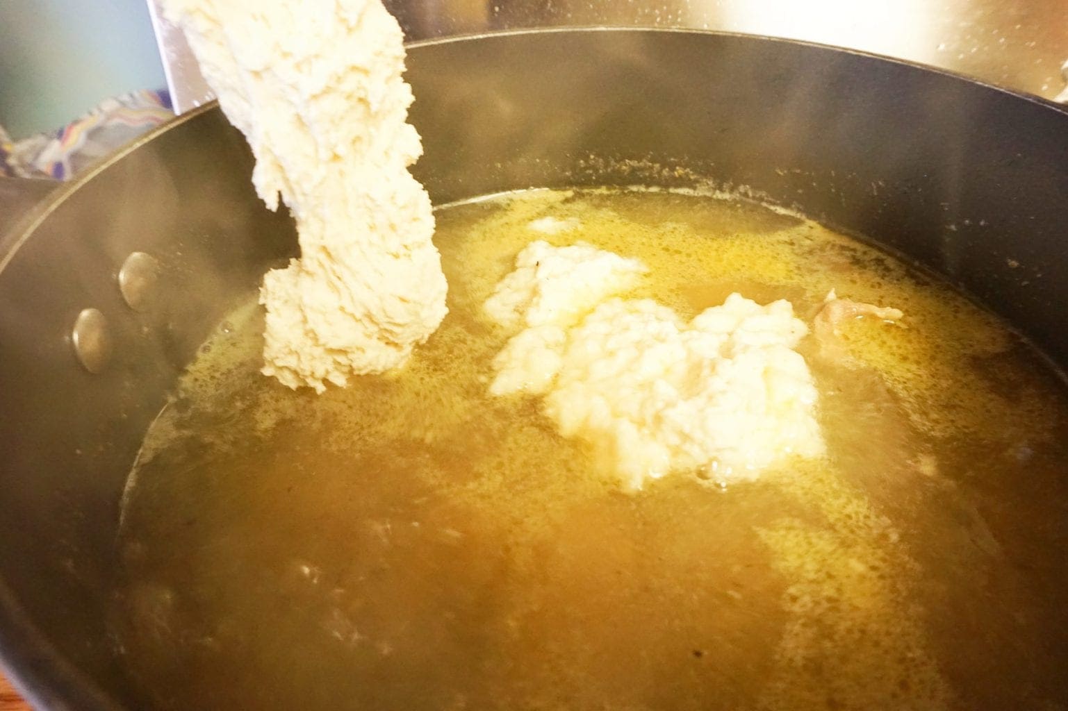 drop biscuits being added to dutch oven